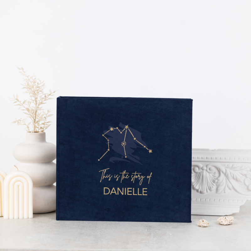 Minimalist baby memory book with fabric cover and customizable details.