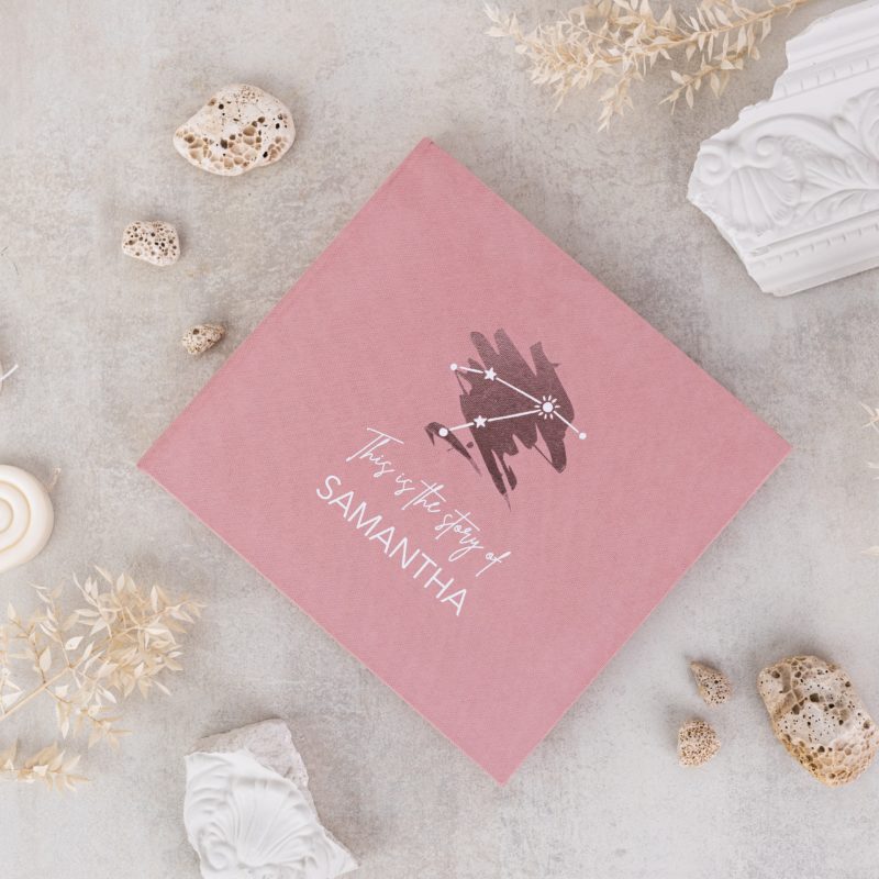 Minimalist baby memory book with fabric cover and customizable details.