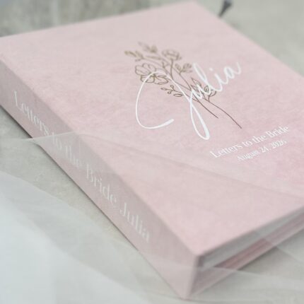 Baby pink scrapbook binder with elegant foil gold and white lettering, personalized Letters to the Bride book with envelopes.