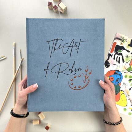 Dusty blue art binder with elegant black lettering.